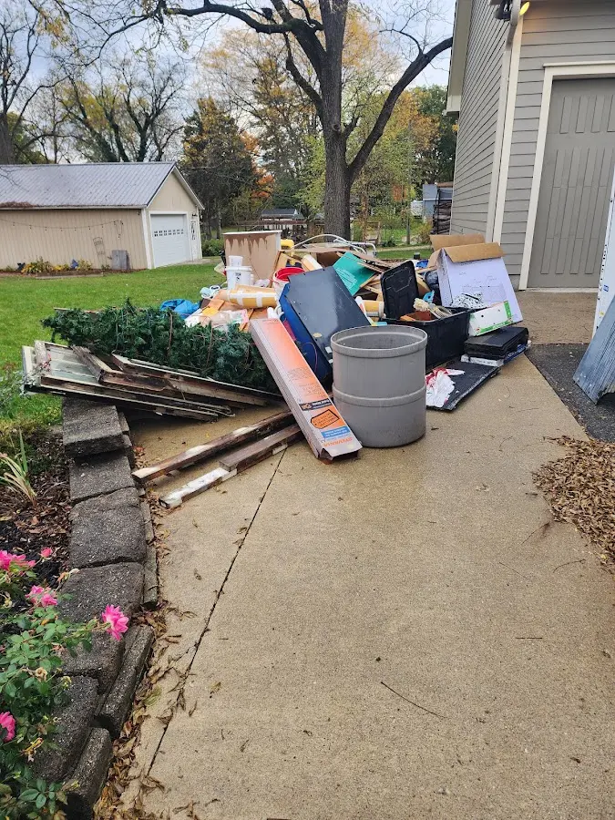 Dumpster being loaded with debris for Estate Cleanout Dumpster Rental in Warren